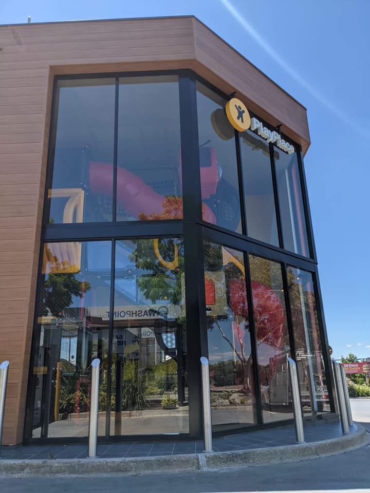 A large building with a lot of windows and a yellow sign — Twin Cities Glass In Albury, NSW