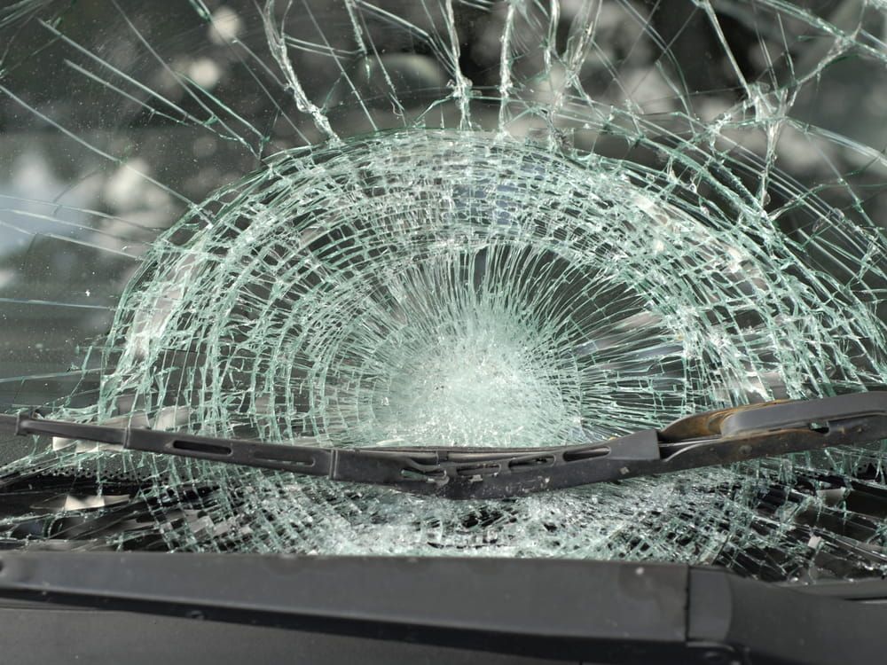 A Close Up of a Broken Windshield With a Wiper Blade — Twin Cities Glass In Albury, NSW