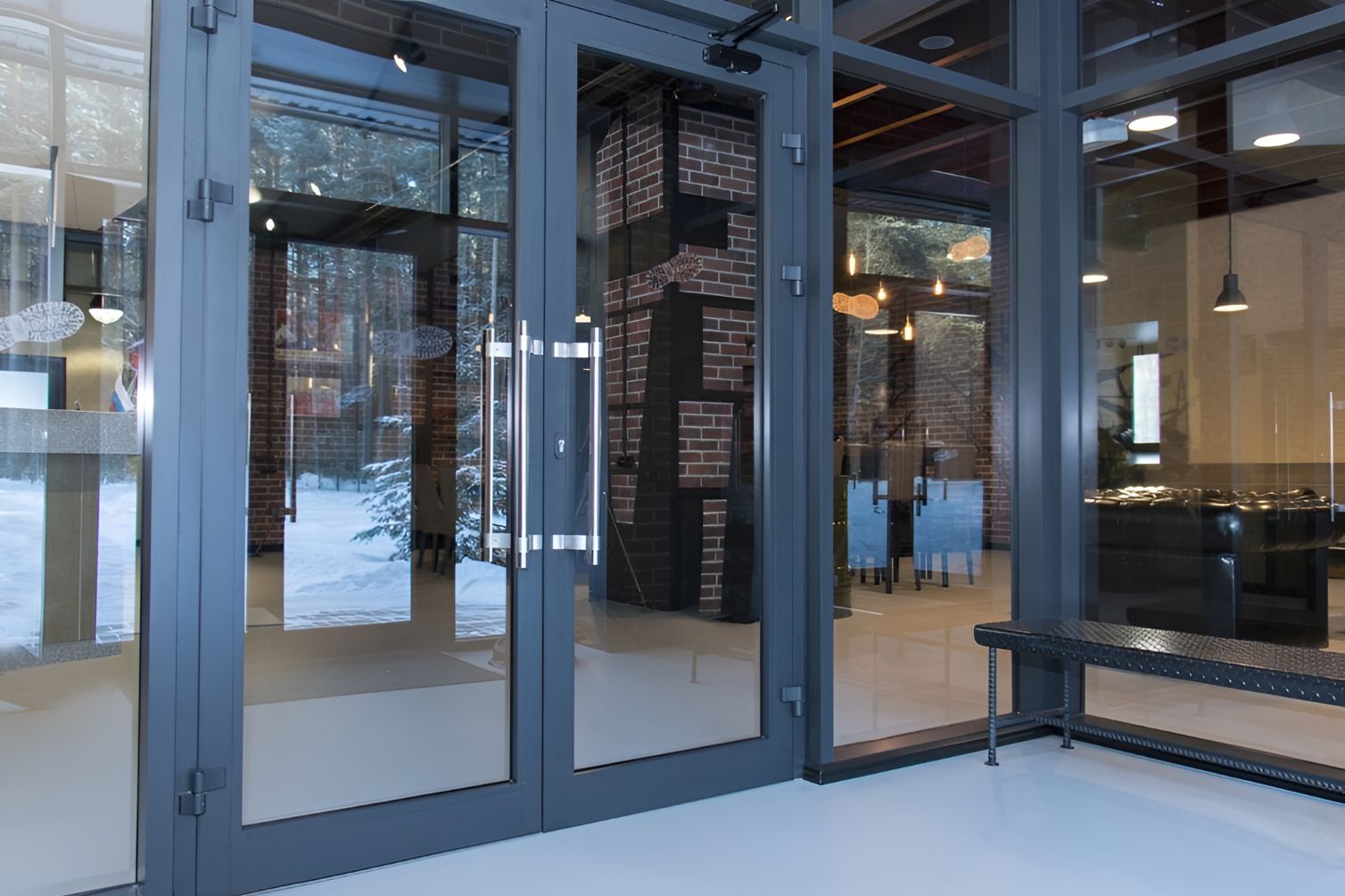 A Large Glass Door in a Building With a Bench in Front of It — Twin Cities Glass In Albury, NSW