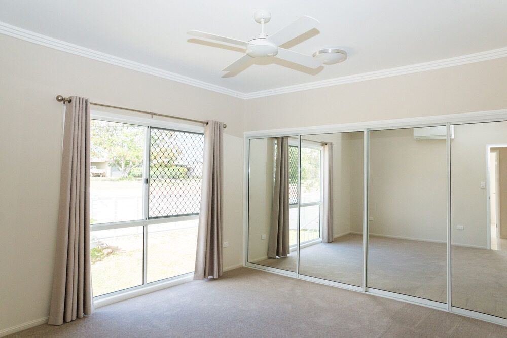 There is a ceiling fan in the room with a lot of mirrors. — Twin Cities Glass In Albury, NSW