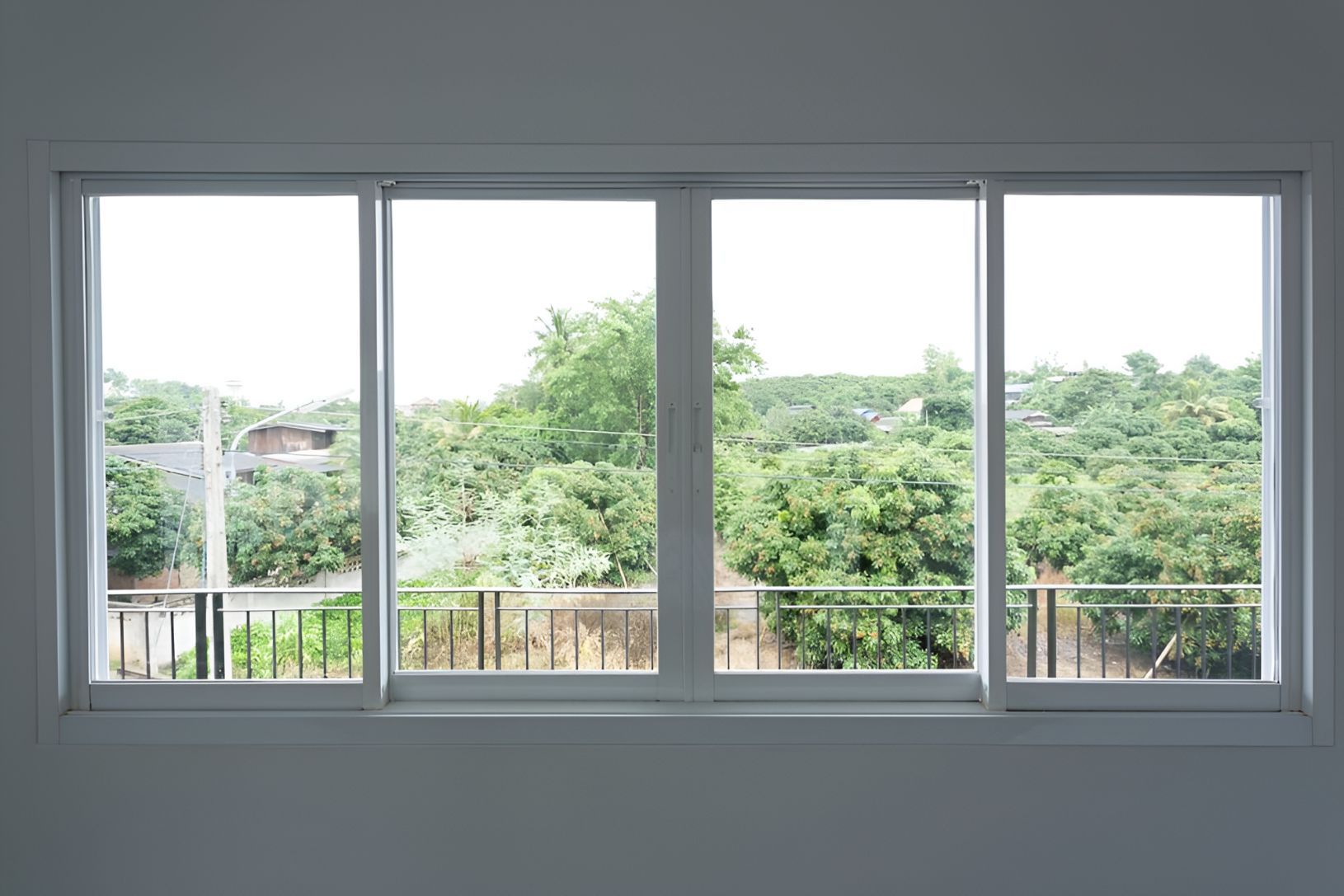 A Large Window With a View of Trees and a Balcony — Twin Cities Glass In Albury, NSW
