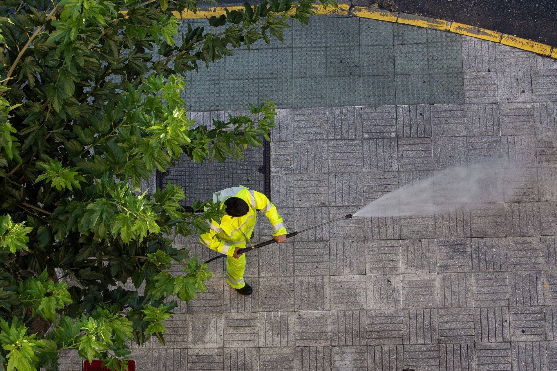 Pressure washing service cleaning a commercial walkway in Goodyear, AZ