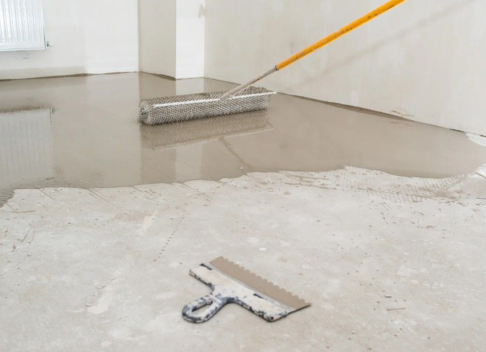 Zest Underfloor Heating Birmingham - spreading screed floor levelling compound