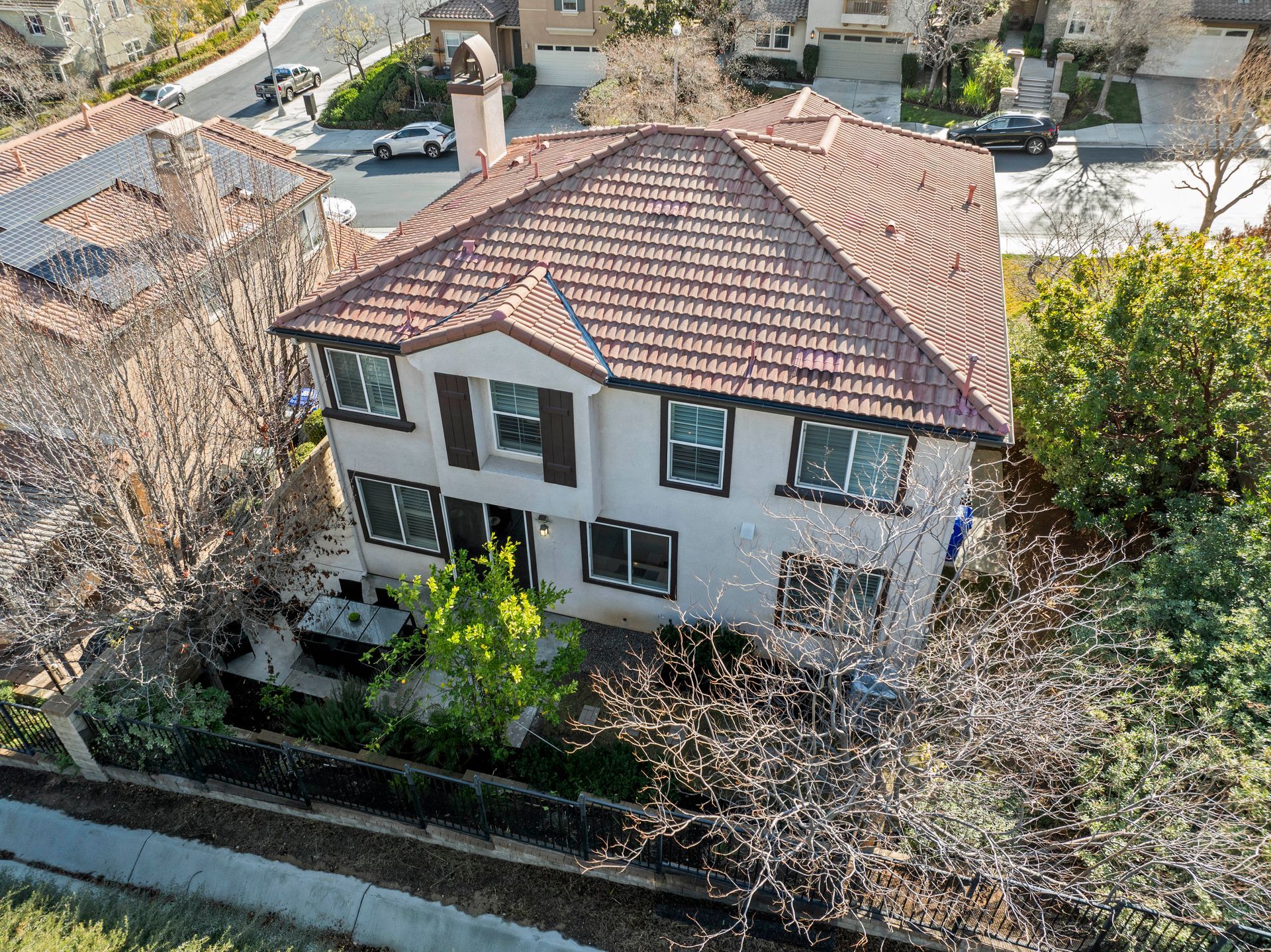 Two-story house with red tile roof, white exterior, shutters | Homes for sale in Santa Clarita, CA
