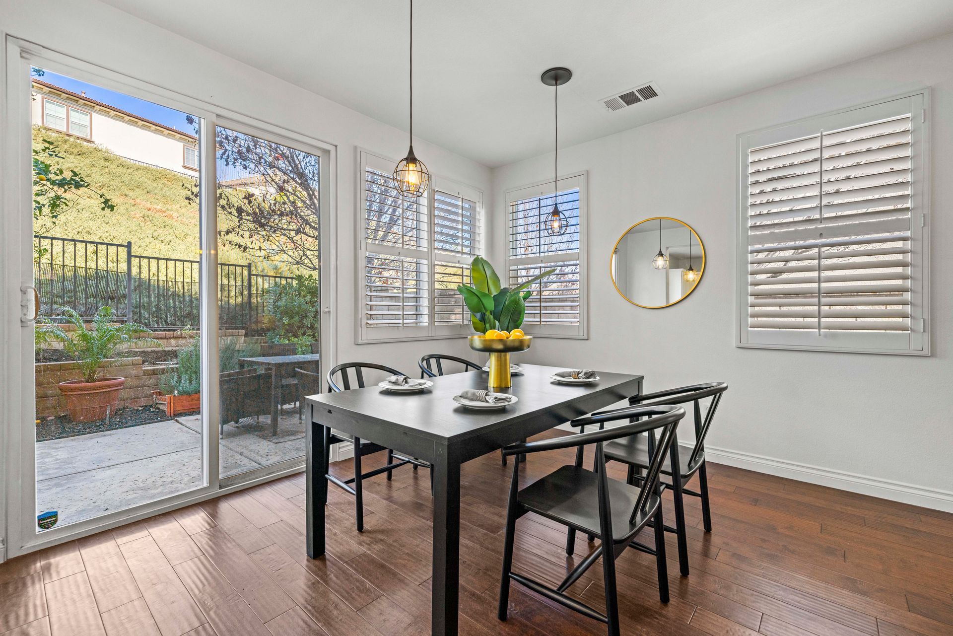 Minimalist dining area with access to the outside through large, sliding doors.