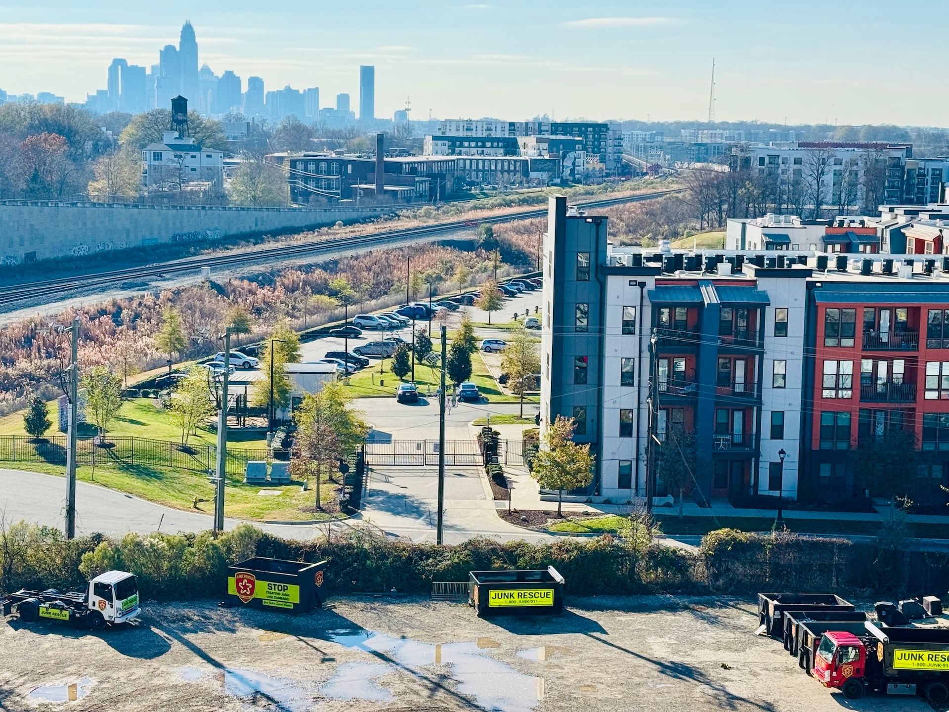 Cityscape with buildings, train tracks, and skyline on a sunny day.