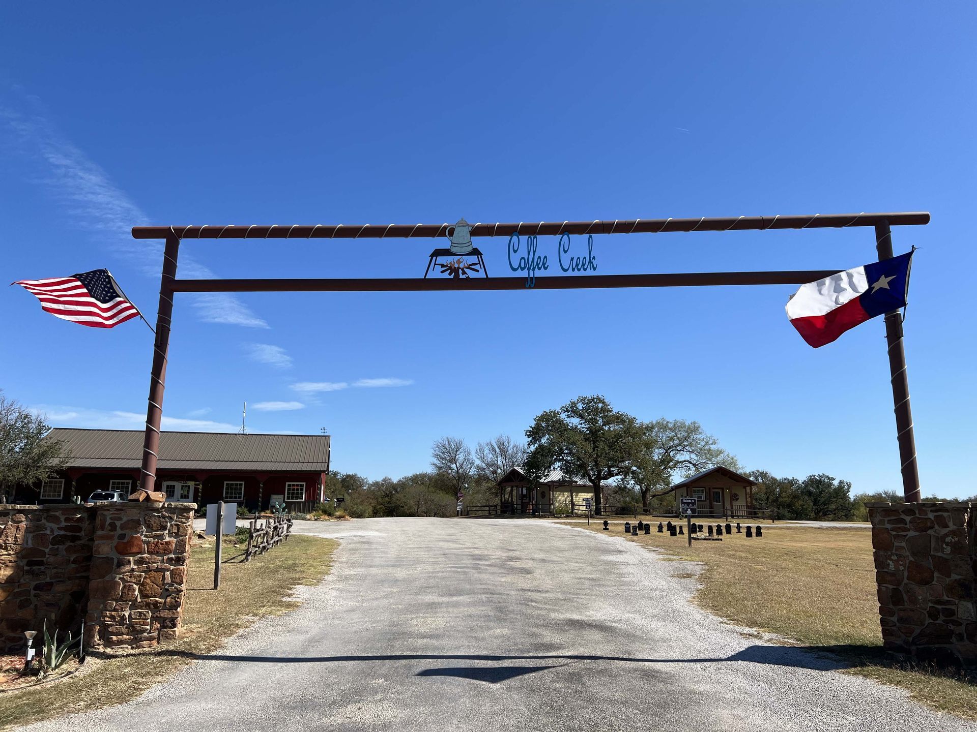 A gate with a texas flag and an american flag on it