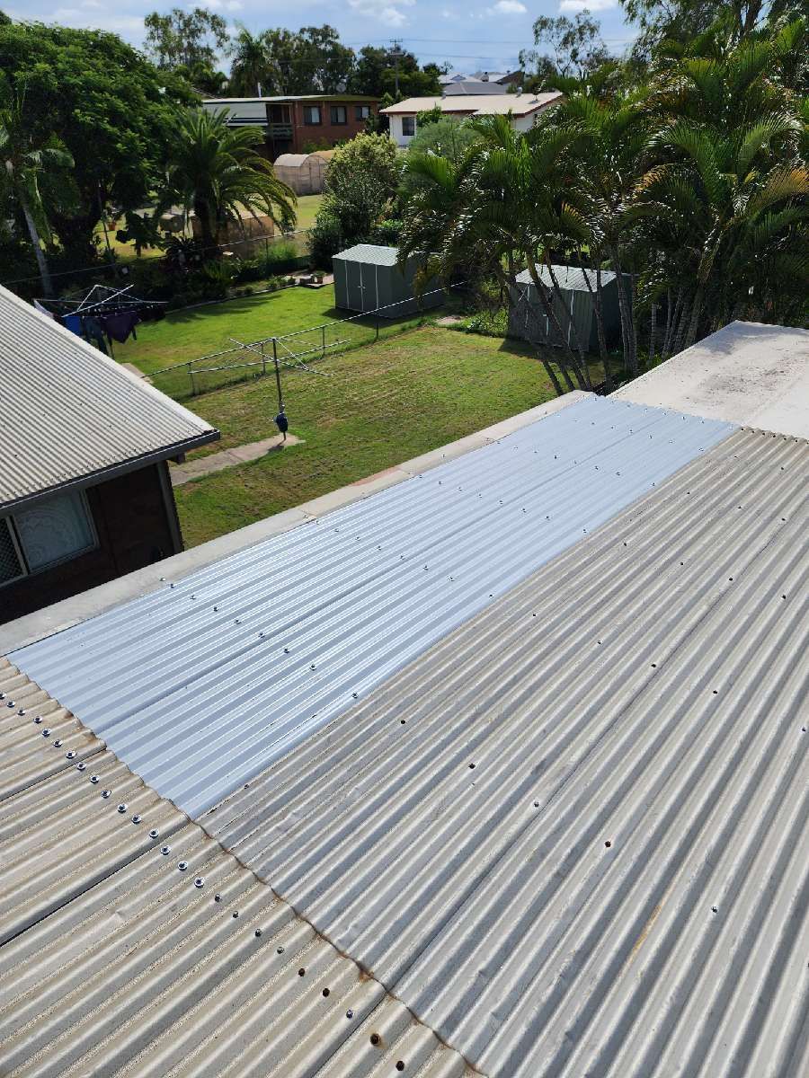 A High-angle View of a Corrugated Metal Roof, Showing a Bright — PlumbPlus in Kawana, QLD