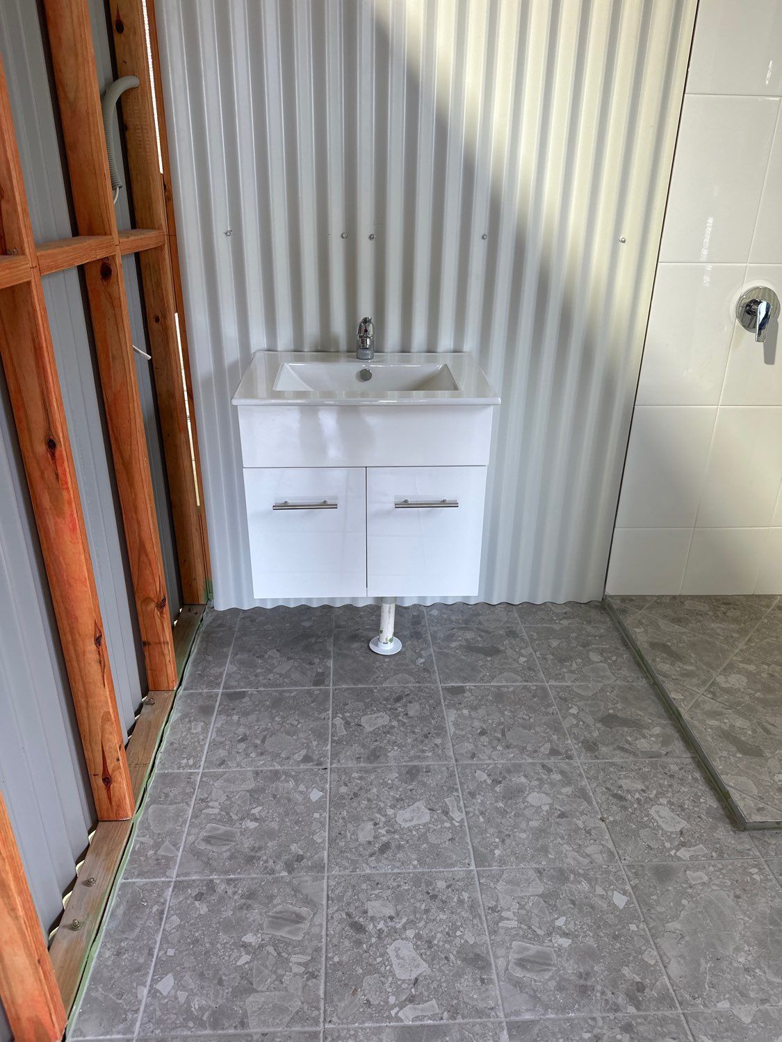 A White Wall-mounted Vanity With a Sink Installed — PlumbPlus in Kawana, QLD