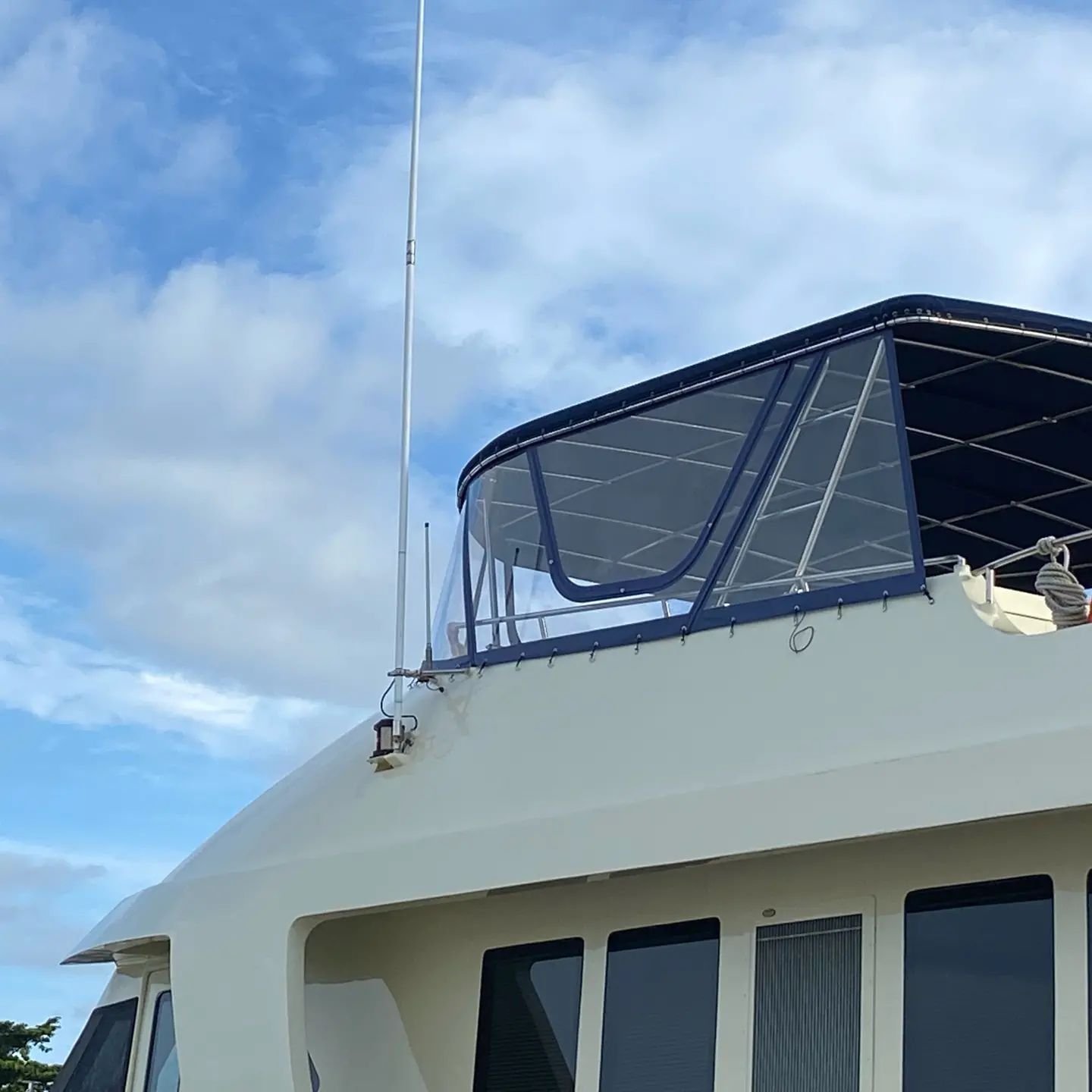A White Boat With a Blue Canopy on Top of It — Coastal Coverings In Port Douglas, QLD