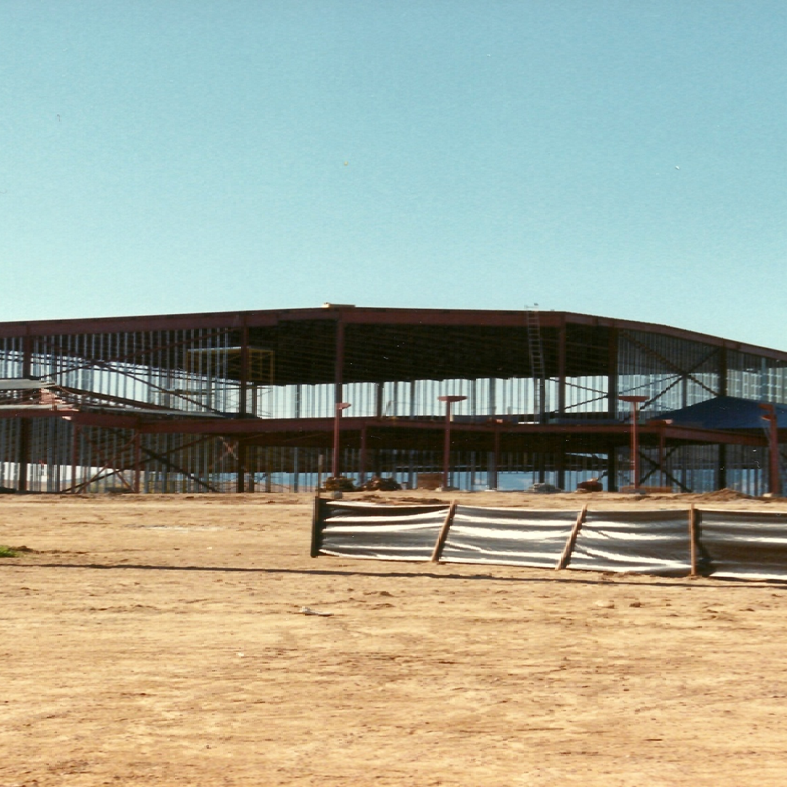A large building under construction with a blue sky in the background