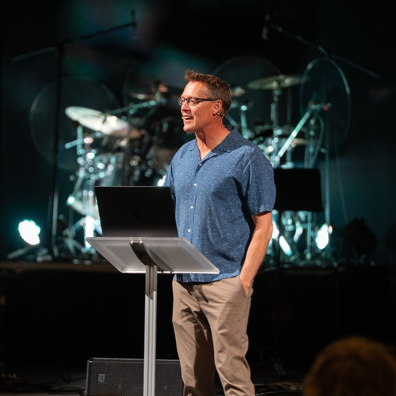 A man stands on a stage in front of a crowd
