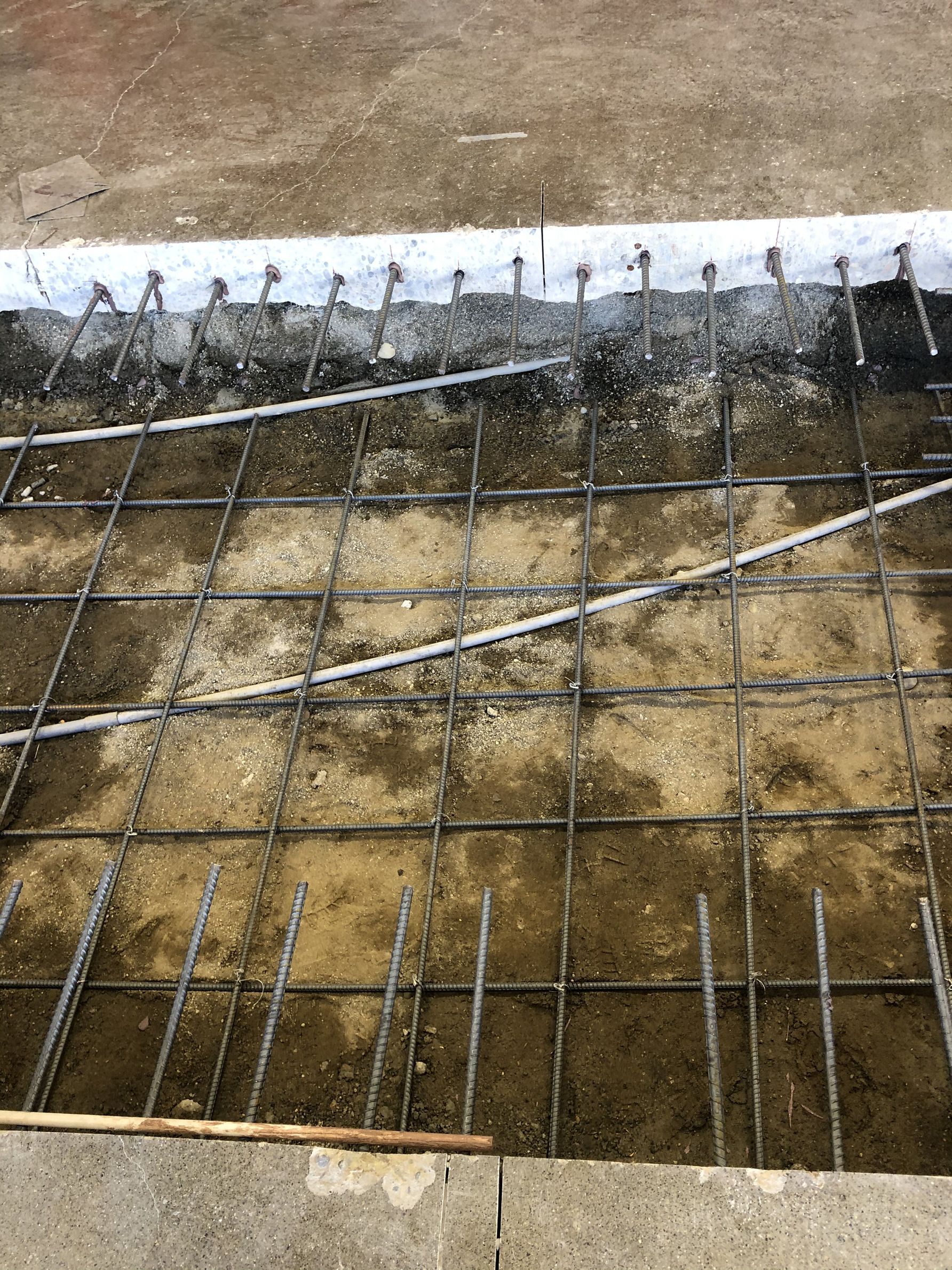 A close up of a concrete floor with a wire mesh.