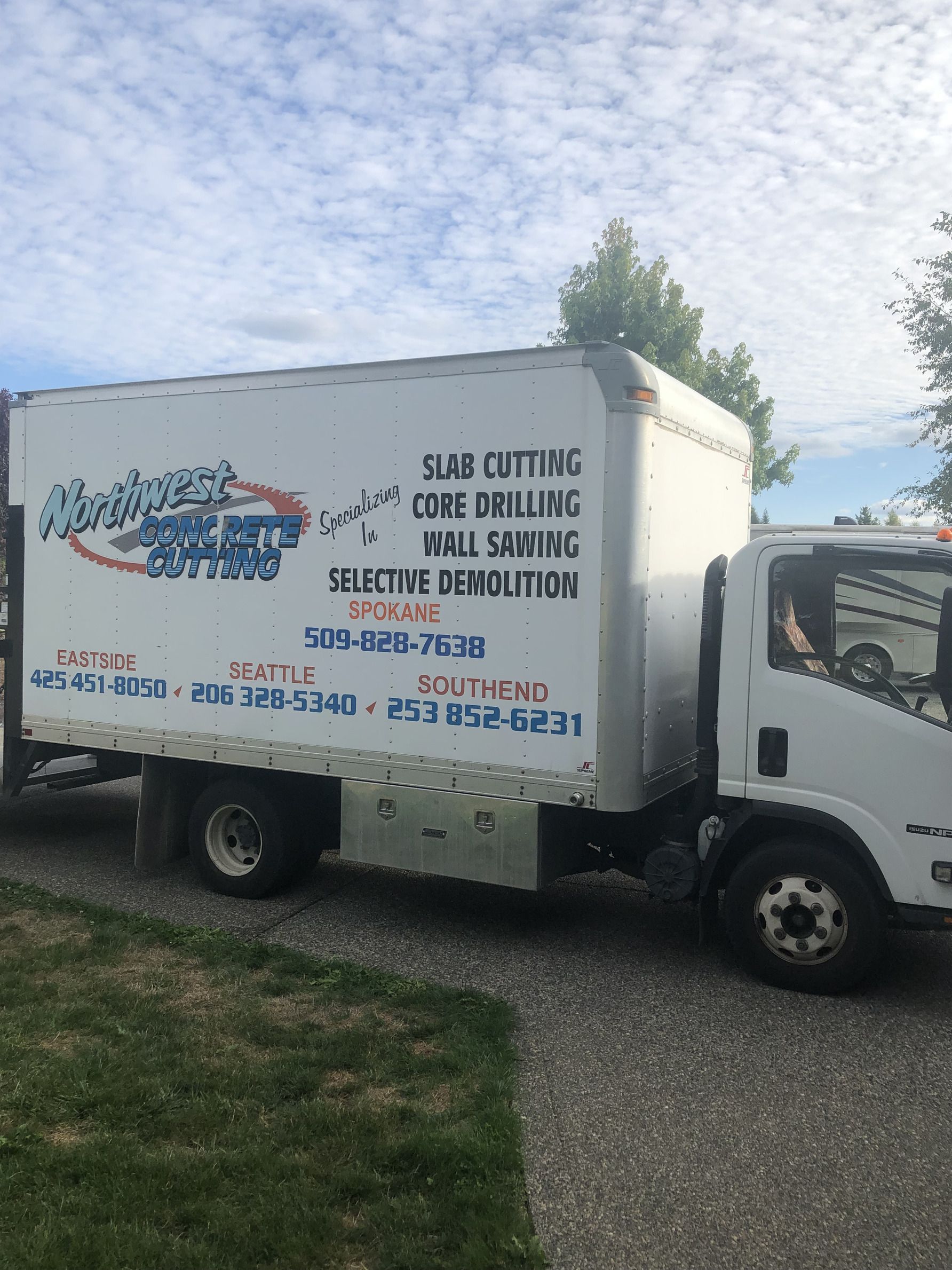 A white truck is parked on the side of the road.