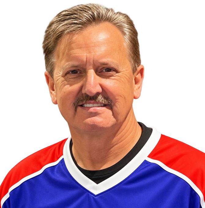 Smiling man in a red, blue, and white hockey jersey against a black background