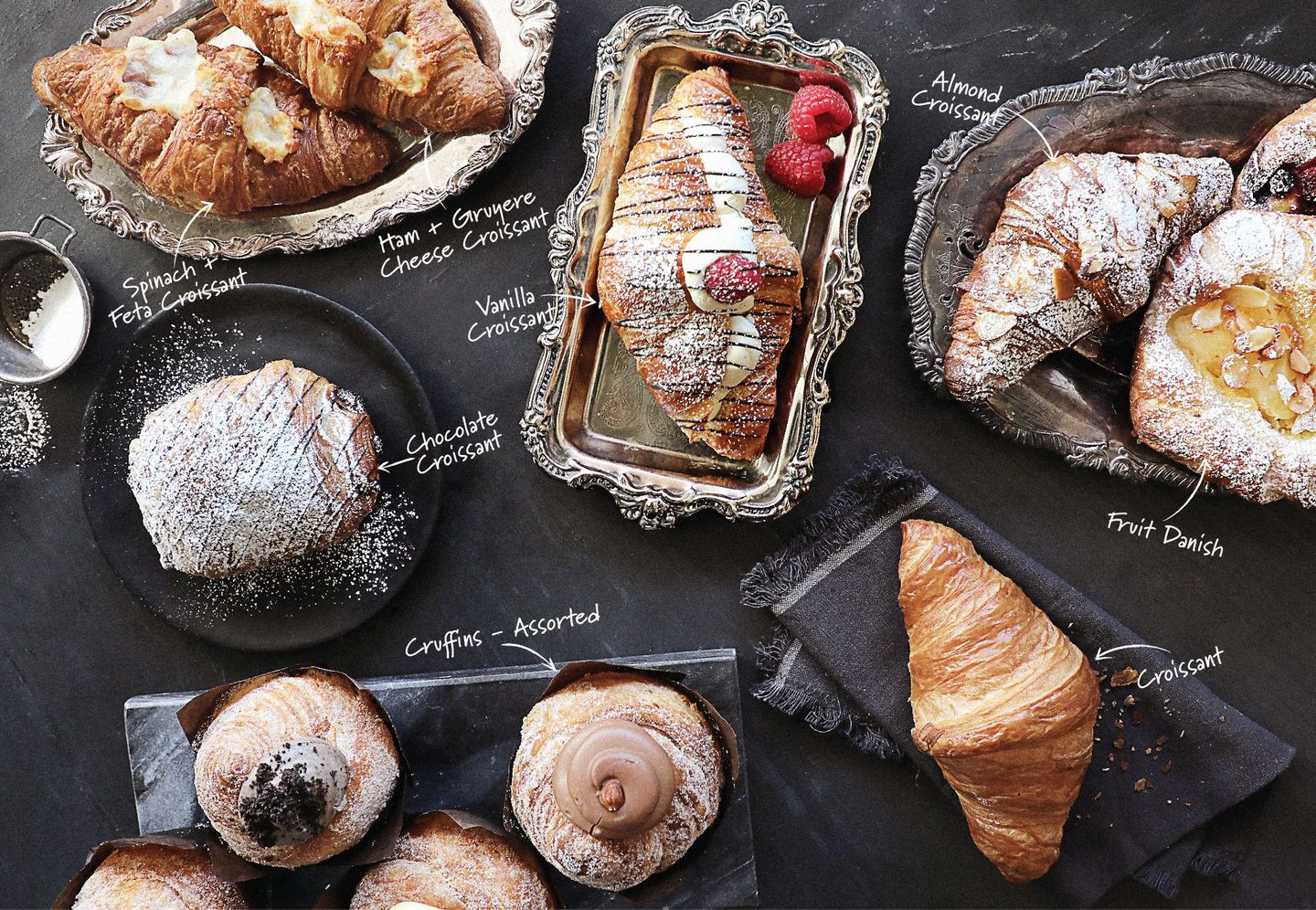 There are many different types of pastries on the table.