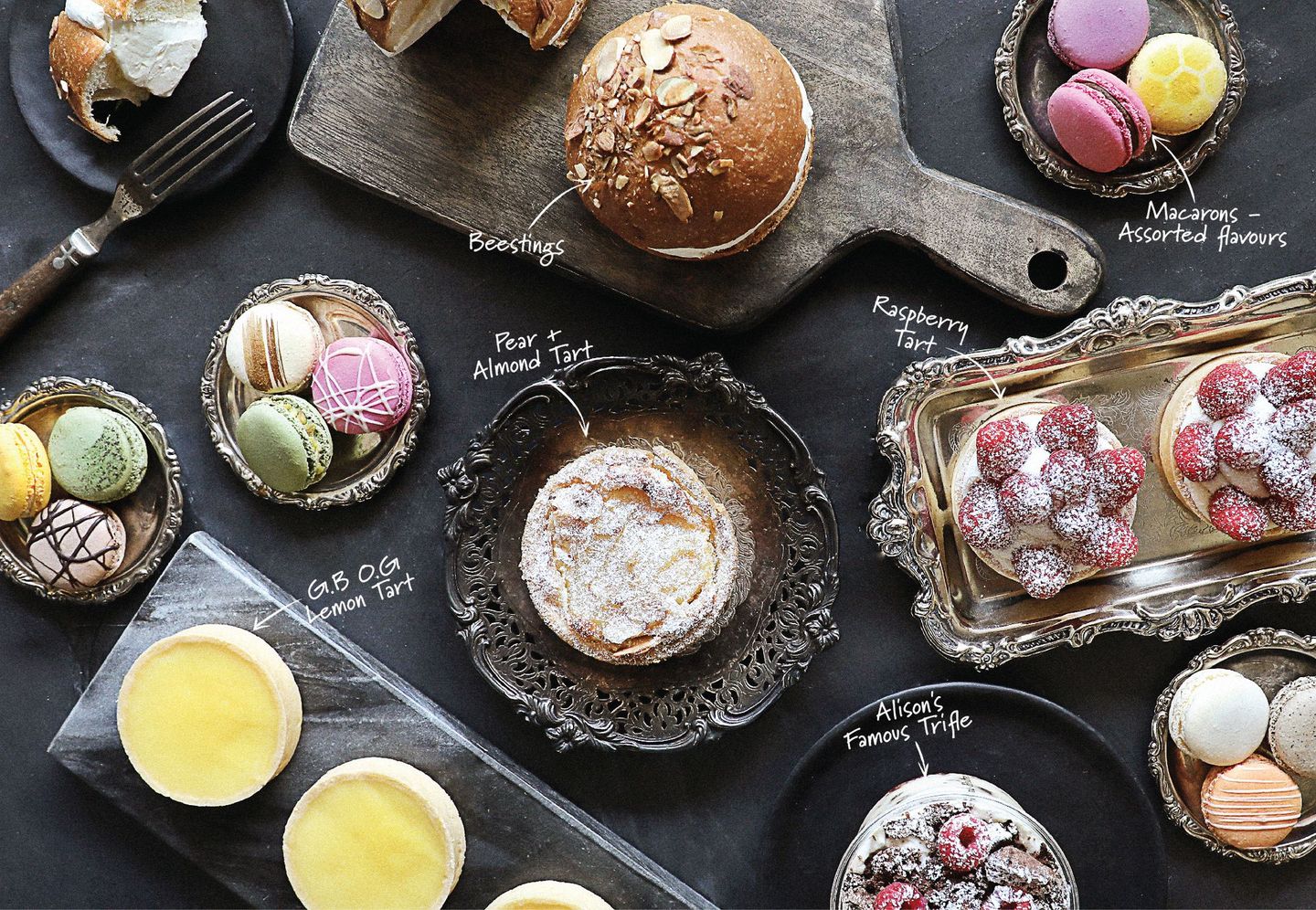 A table topped with a variety of desserts including macarons and pastries