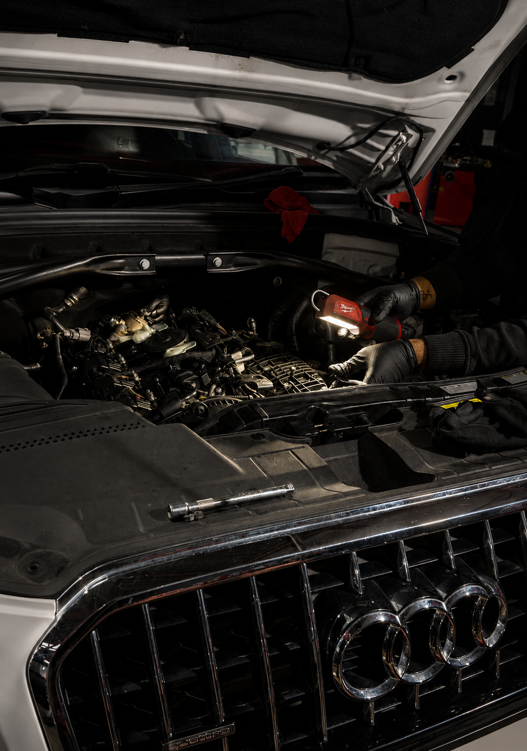Audi car engine bay with hood open and visible damage near the front grille - at Absolute Motors Morningside