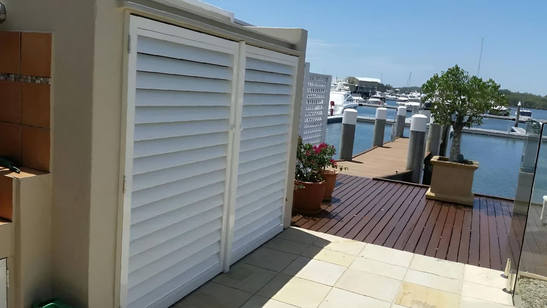 A Wooden Deck With a Dock and Boats in the Background — Lismore Curtains & Blinds In Lismore, NSW