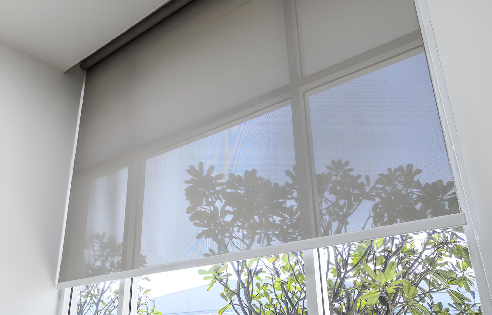 A Close Up of a Window With a Roller Blind on It — Lismore Curtains & Blinds In Lismore, NSW