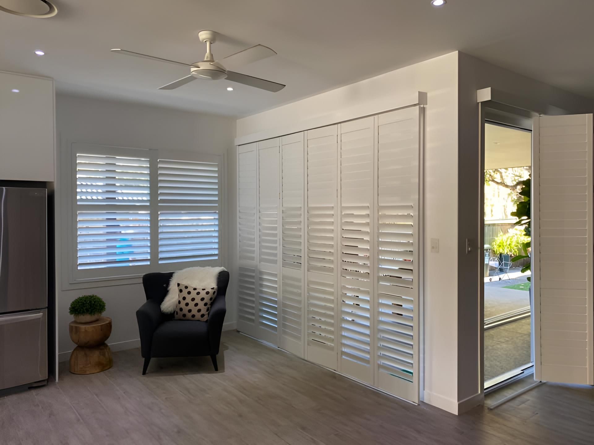 A Living Room With a Chair and a Ceiling Fan — Lismore Curtains & Blinds In Lismore, NSW