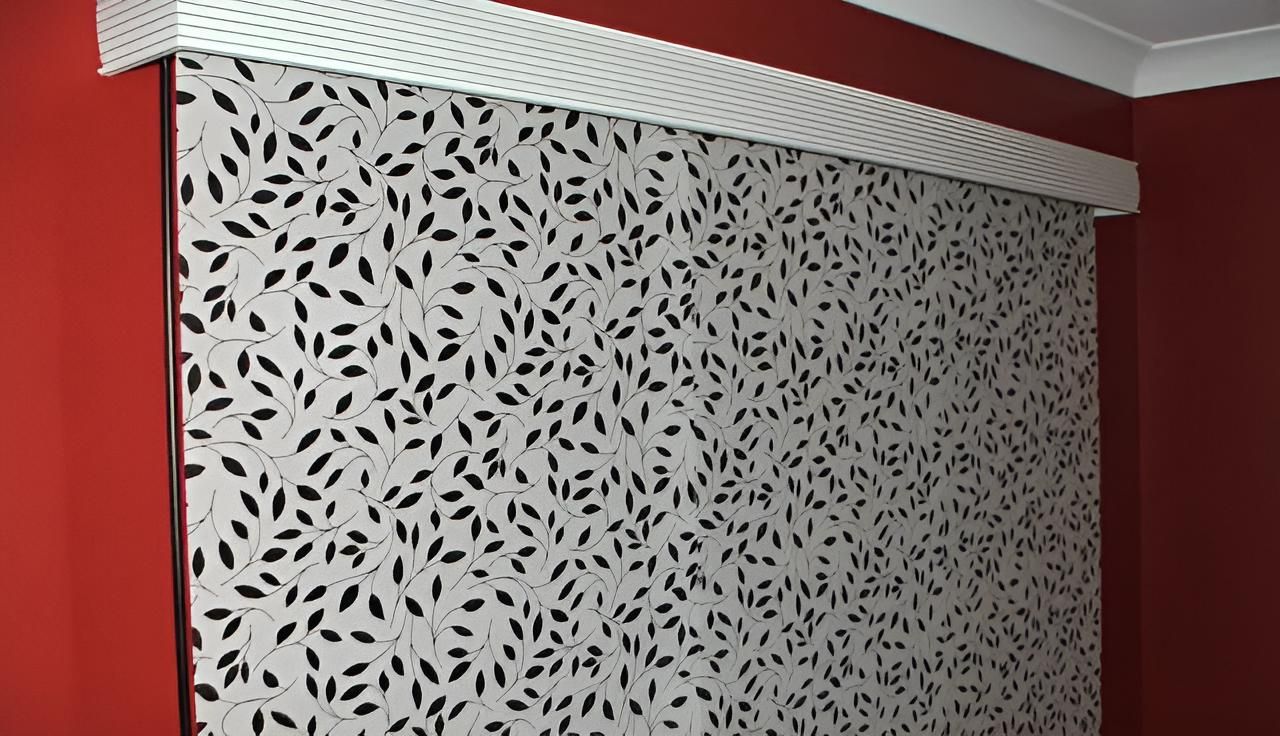 A Red Wall With a White Blind With Black Leaves on It — Lismore Curtains & Blinds In Lismore, NSW