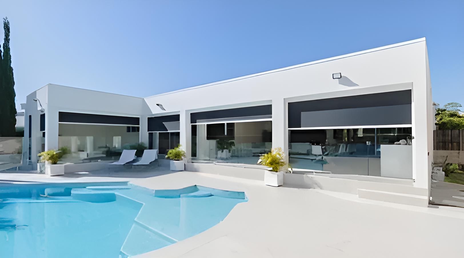 A Large White House With a Swimming Pool in Front of It — Lismore Curtains & Blinds In Lismore, NSW