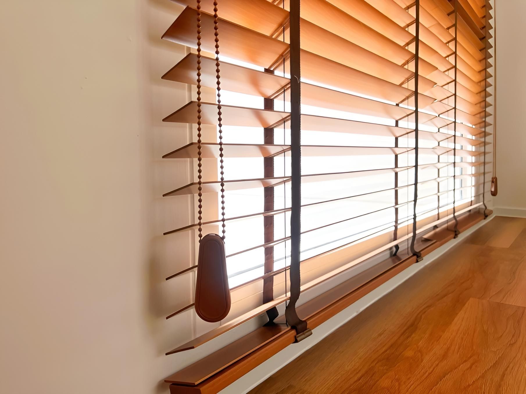 A Window With Wooden Blinds and a Wooden Floor — Lismore Curtains & Blinds In Ballina, NSW
