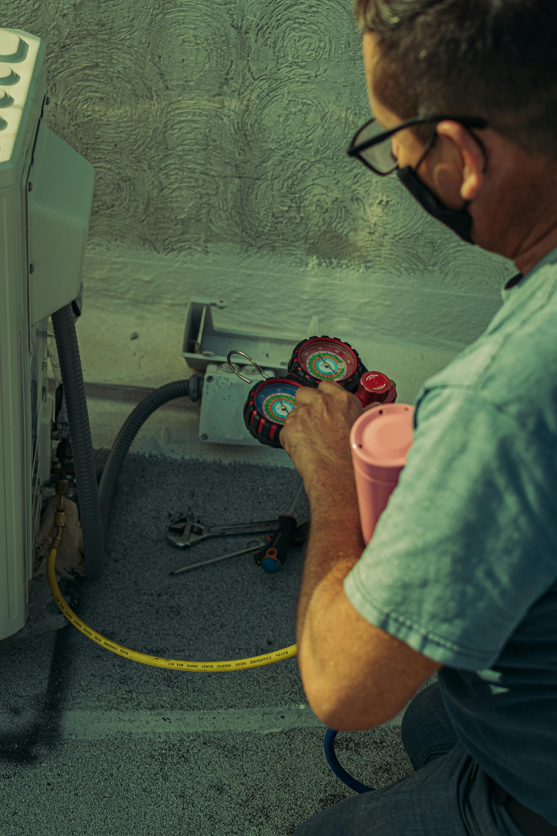 A man is working on a heat pump.