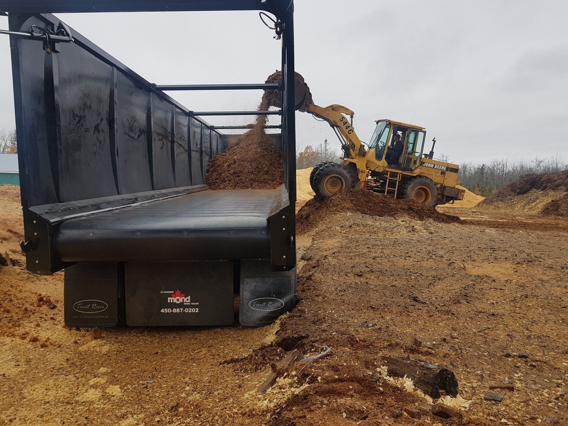 Hycube trailer being loaded with mulch