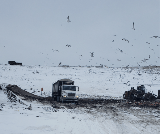 Trout River Industries Hycube trailer driving in a waste landfill