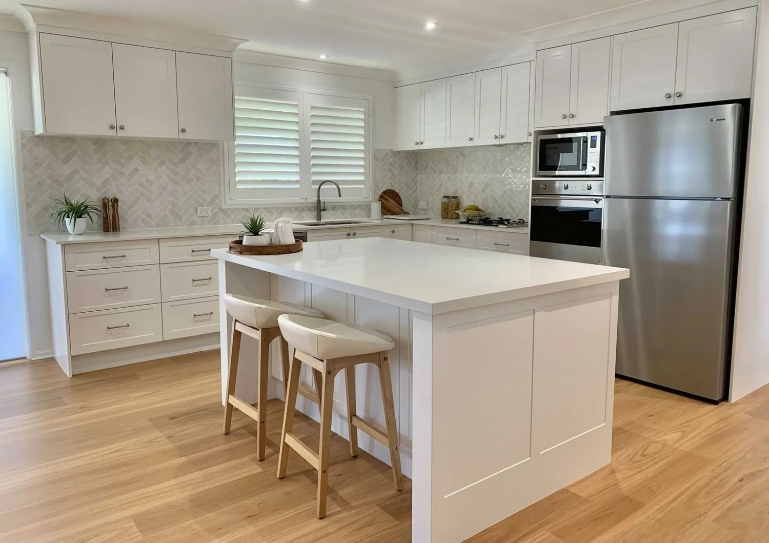 A Kitchen With White Cabinets, Stainless Steel Appliances — The Kitchen Centre In Tuggerah, NSW