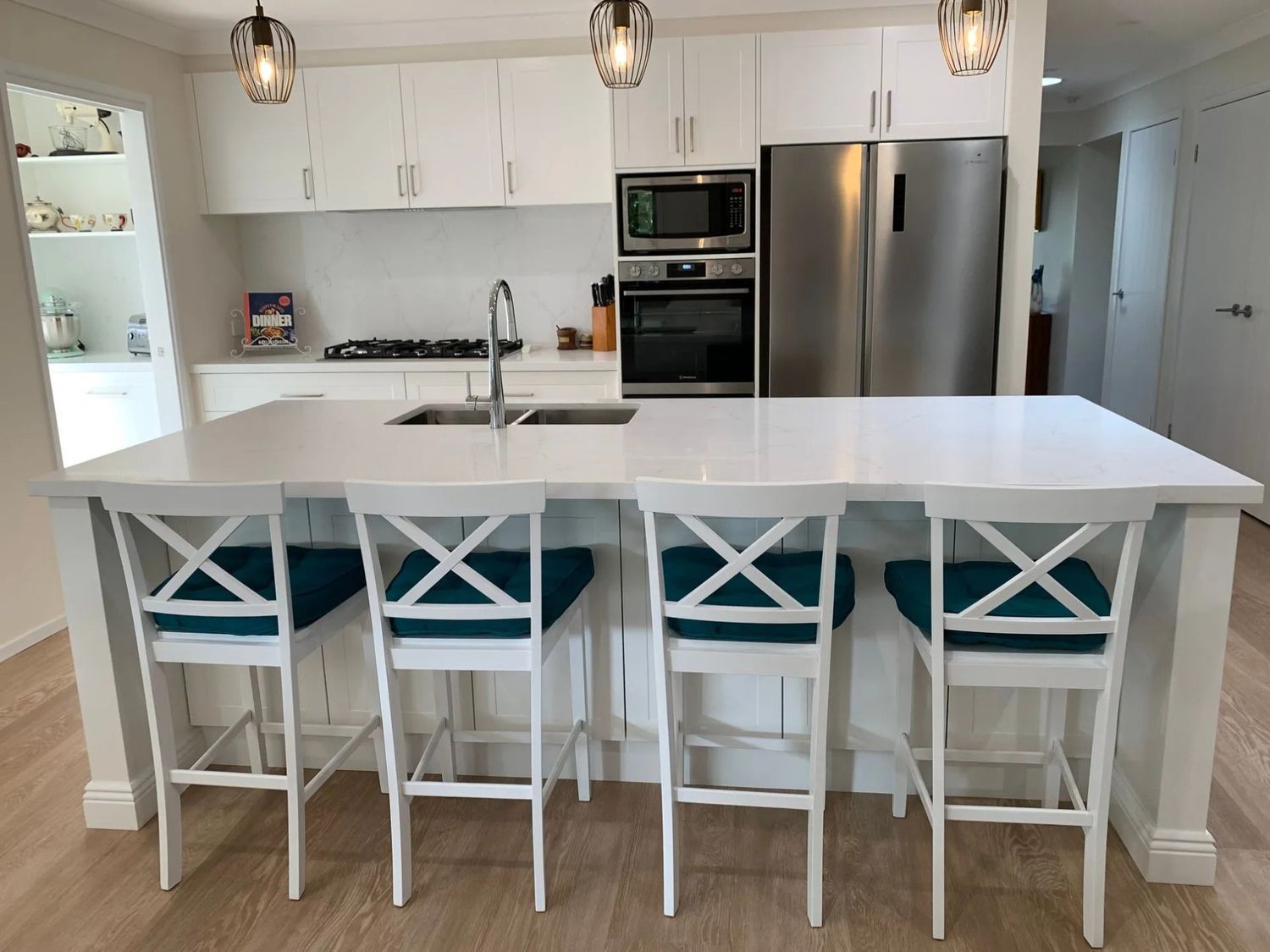 A Kitchen With White Cabinets and a Stainless Steel Refrigerator — The Kitchen Centre In Tuggerah, NSW