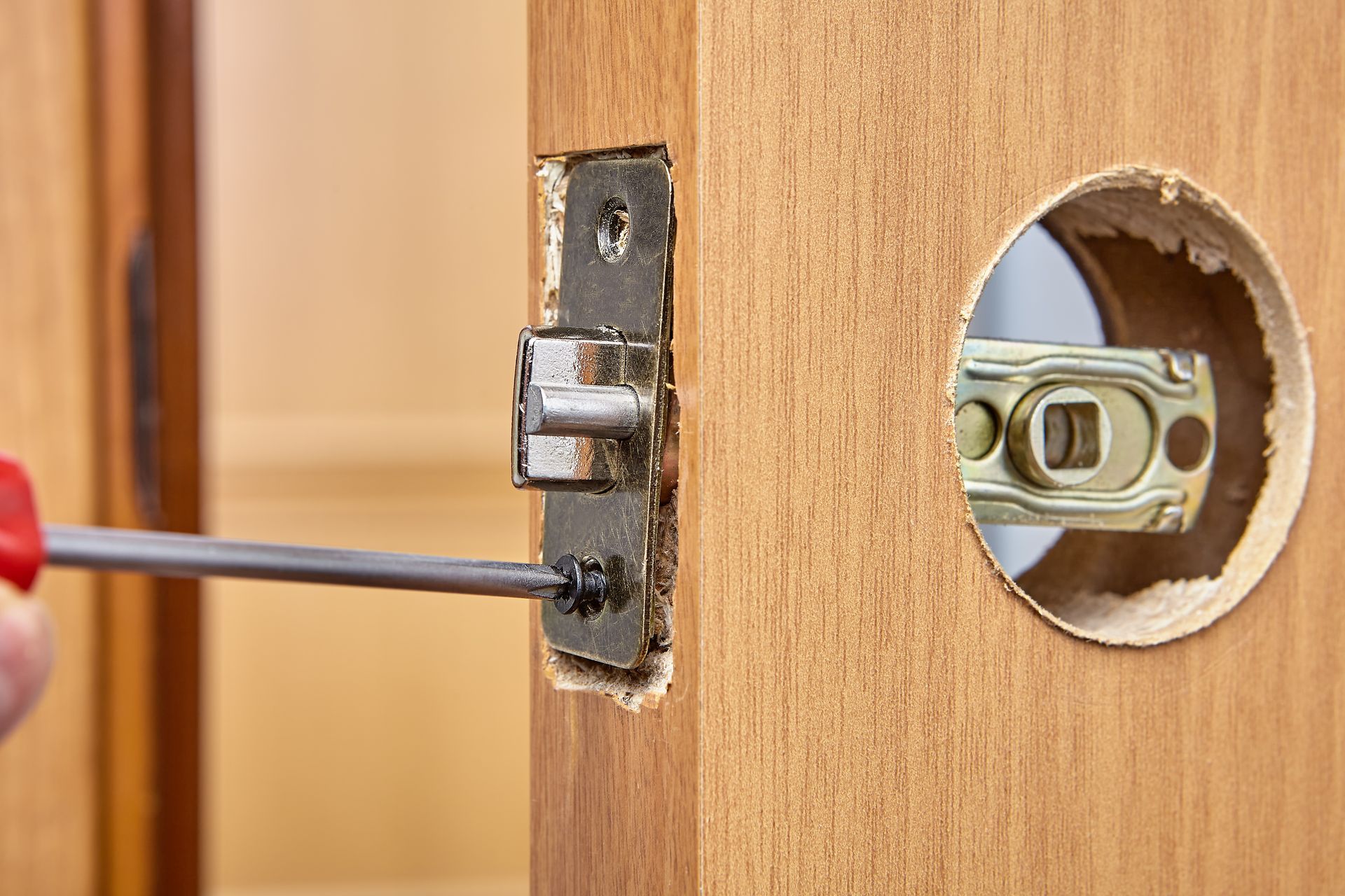 locksmith changing lock on wooden door