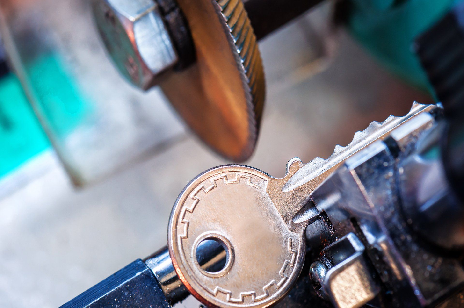 Key cutting machine cutting a replacement key at R&R Security in Ealing