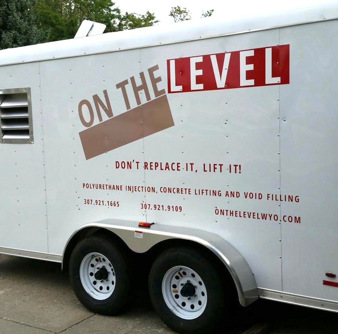 A white trailer with on the level written on it
