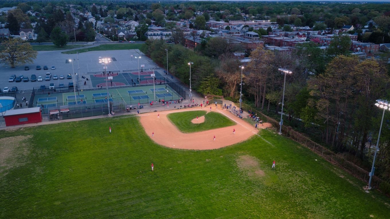 Baseball on a dark surface, with visible stitching.