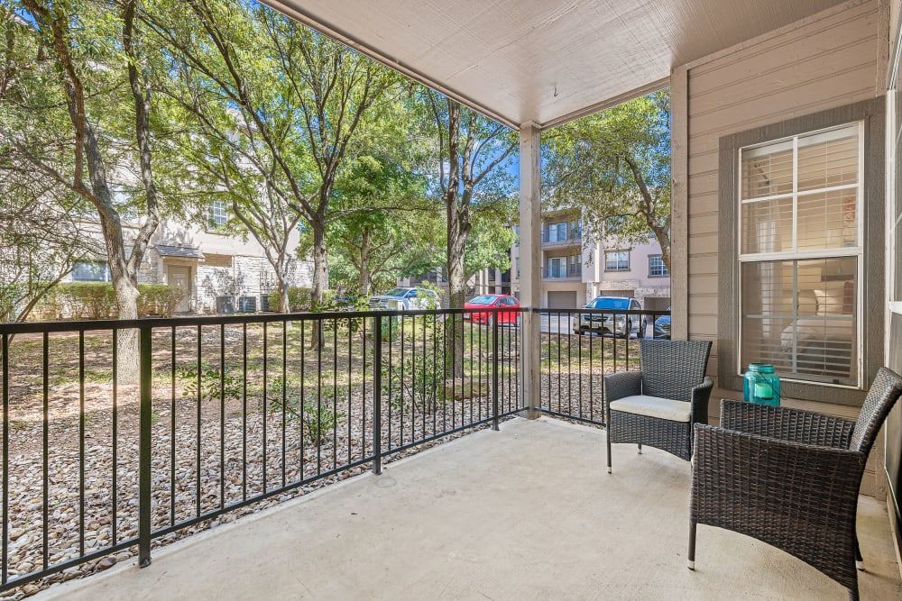a porch with a chair and a table on it at Marquis at Ladera Vista in Austin, TX.