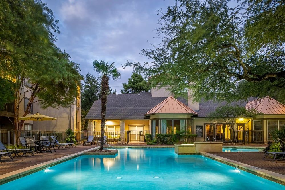 a large swimming pool in front of a building at Marquis at Ladera Vista in Austin, TX.