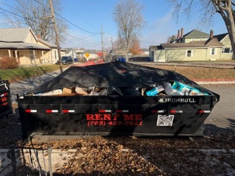 A black rental dumpster, labeled 