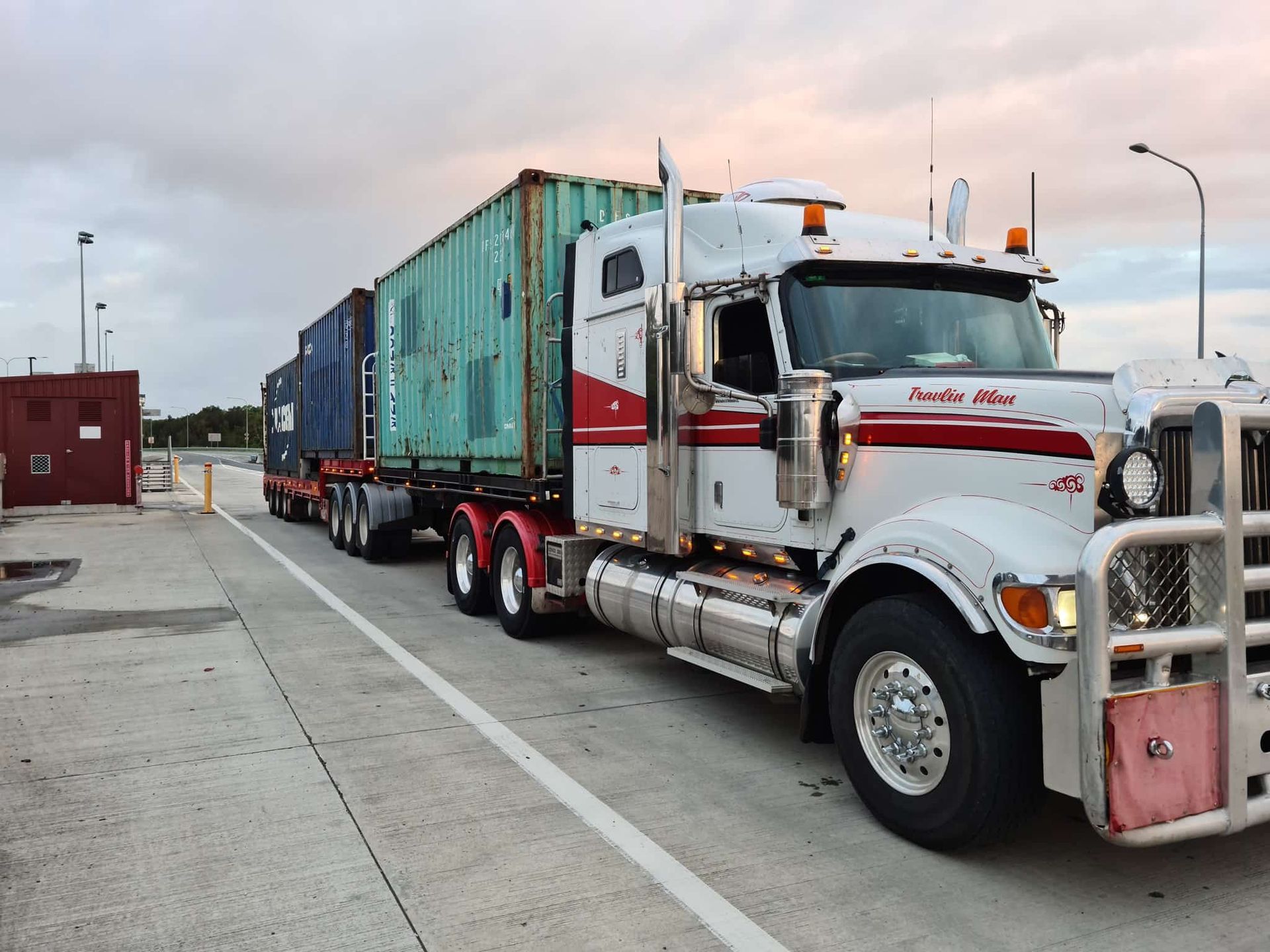 A Semi Truck Is Pulling A Trailer With Containers On It — Equiptranz In Kybong, QLD
