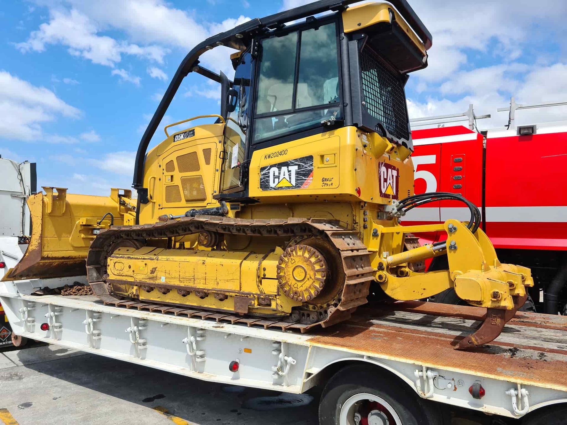 A Bulldozer Is Sitting On Top Of A Flatbed Truck — Equiptranz In Kybong, QLD