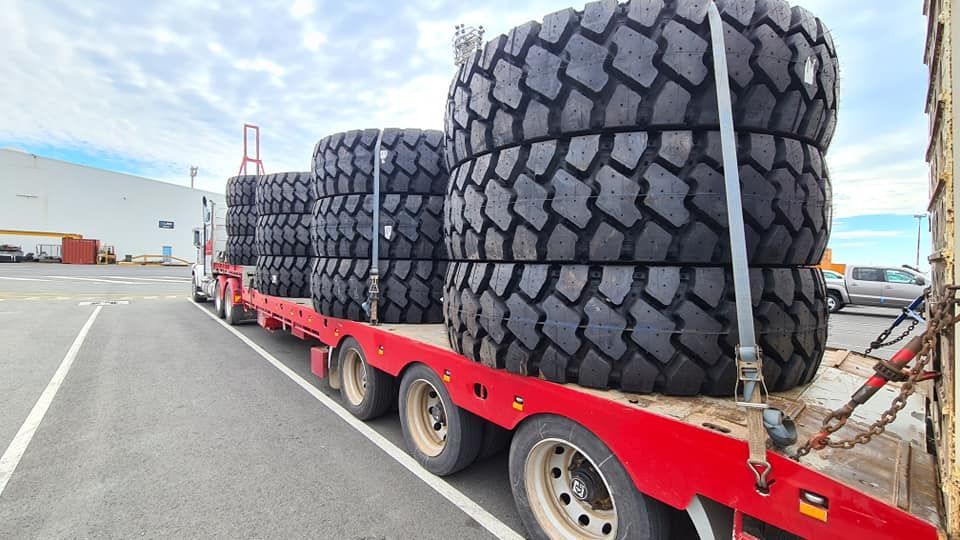 A Red Trailer With A Bunch Of Tires On It — Equiptranz In Kybong, QLD