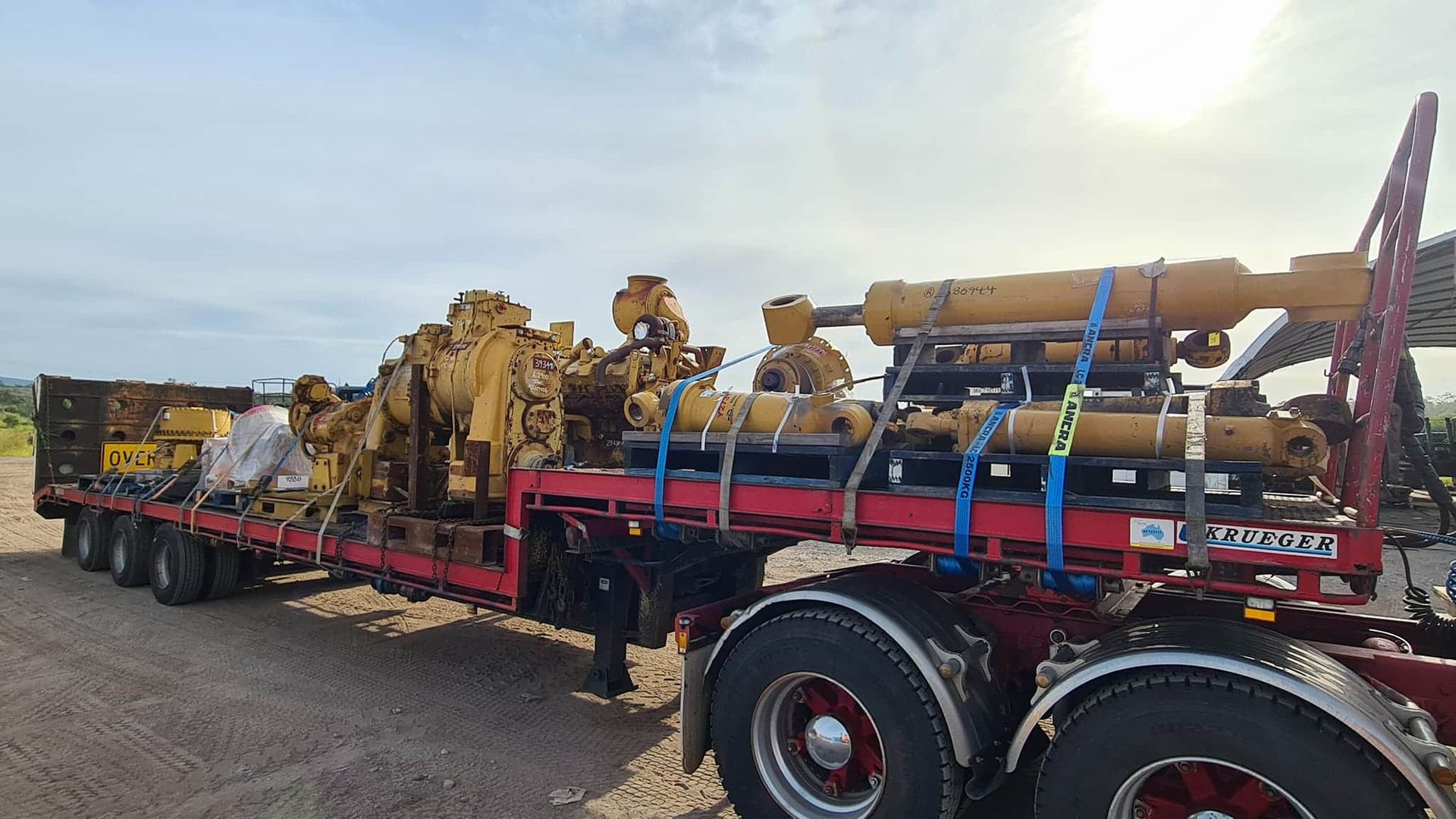 A Semi Truck Is Carrying A Lot Of Machinery On A Flatbed Trailer — Equiptranz In Kybong, QLD