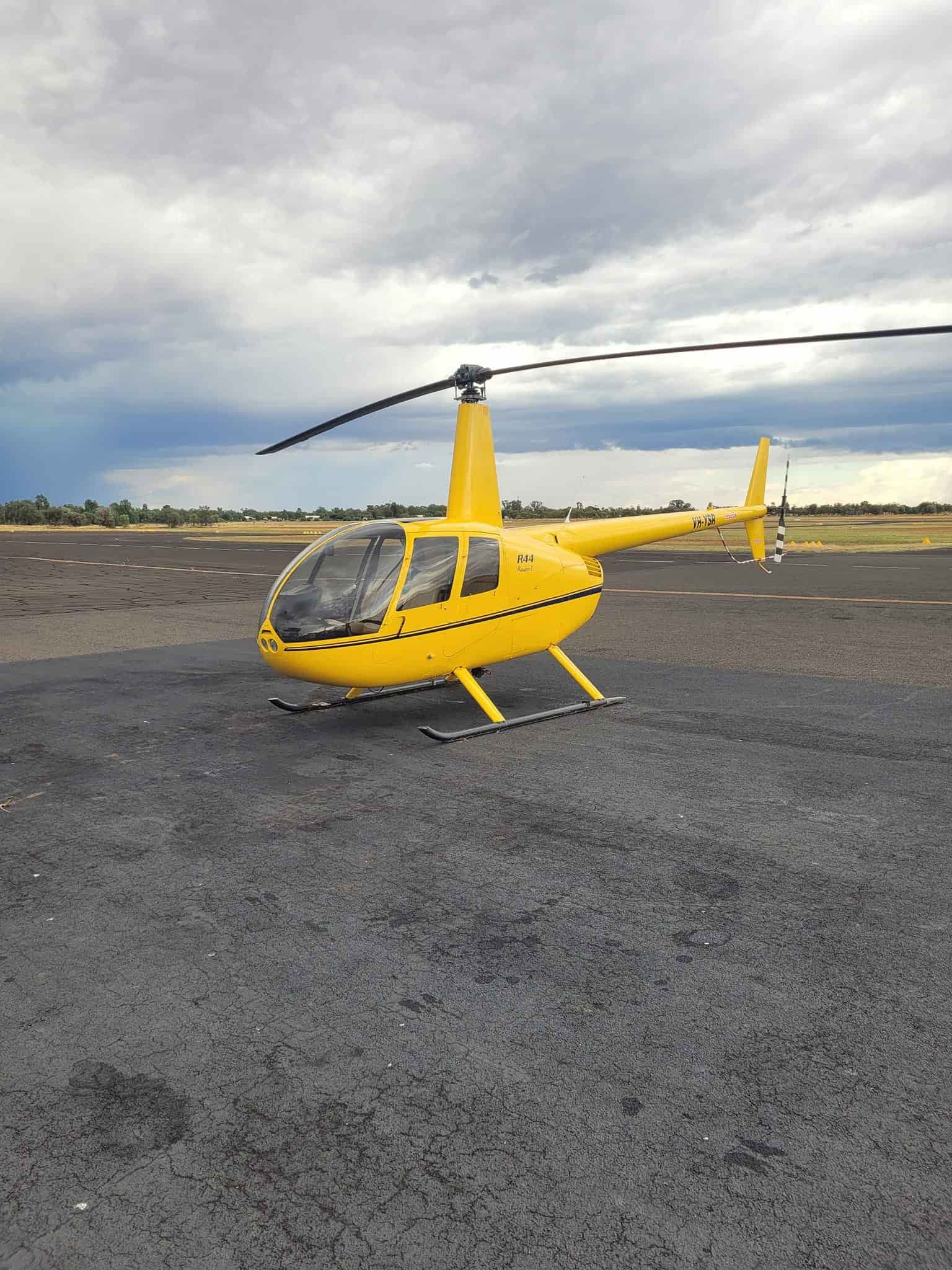 A Small Yellow Helicopter Is Parked On A Runway — Equiptranz In Kybong, QLD