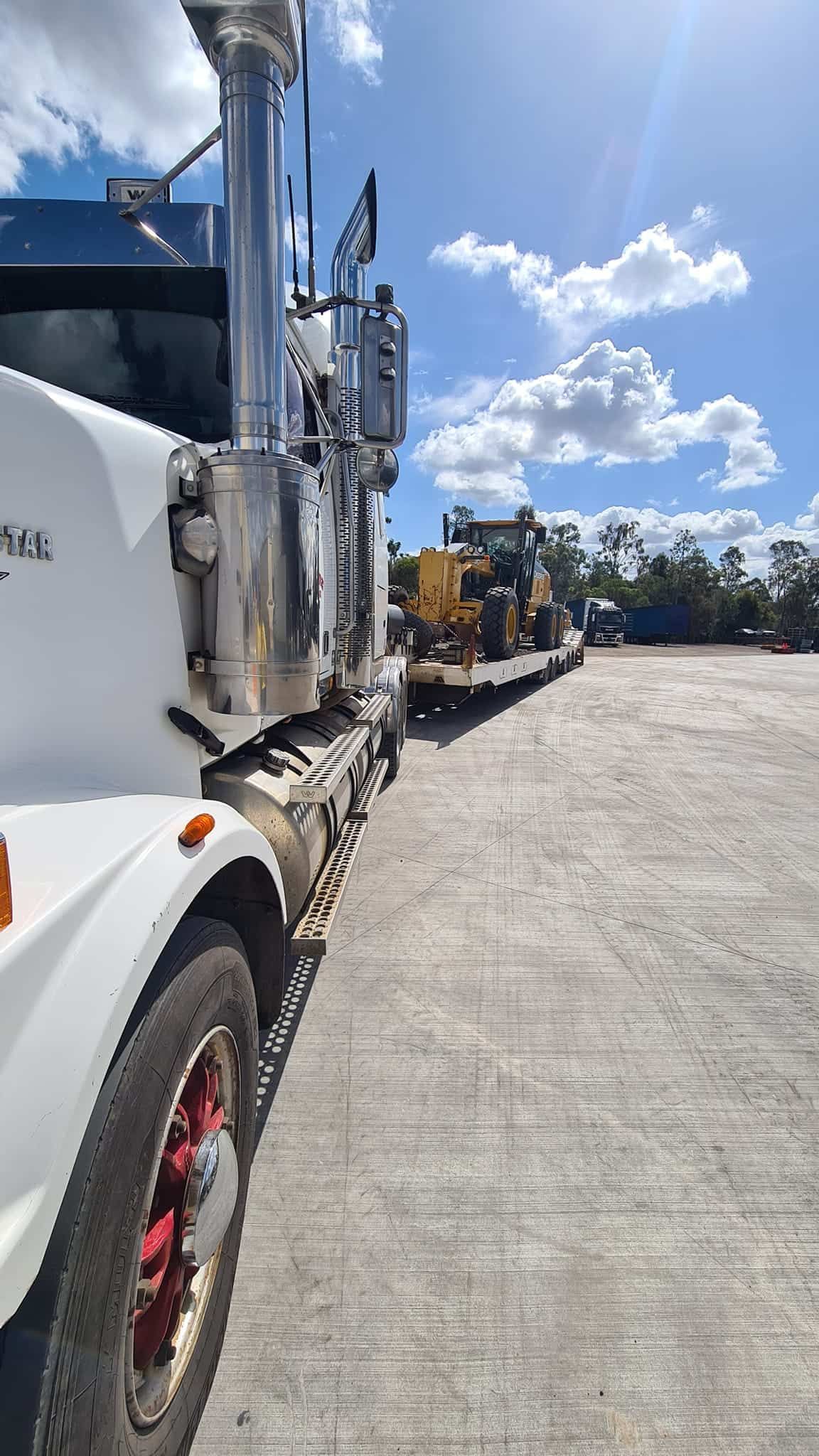 A Row Of Semi Trucks Are Parked In A Parking Lot — Equiptranz In Kybong, QLD
