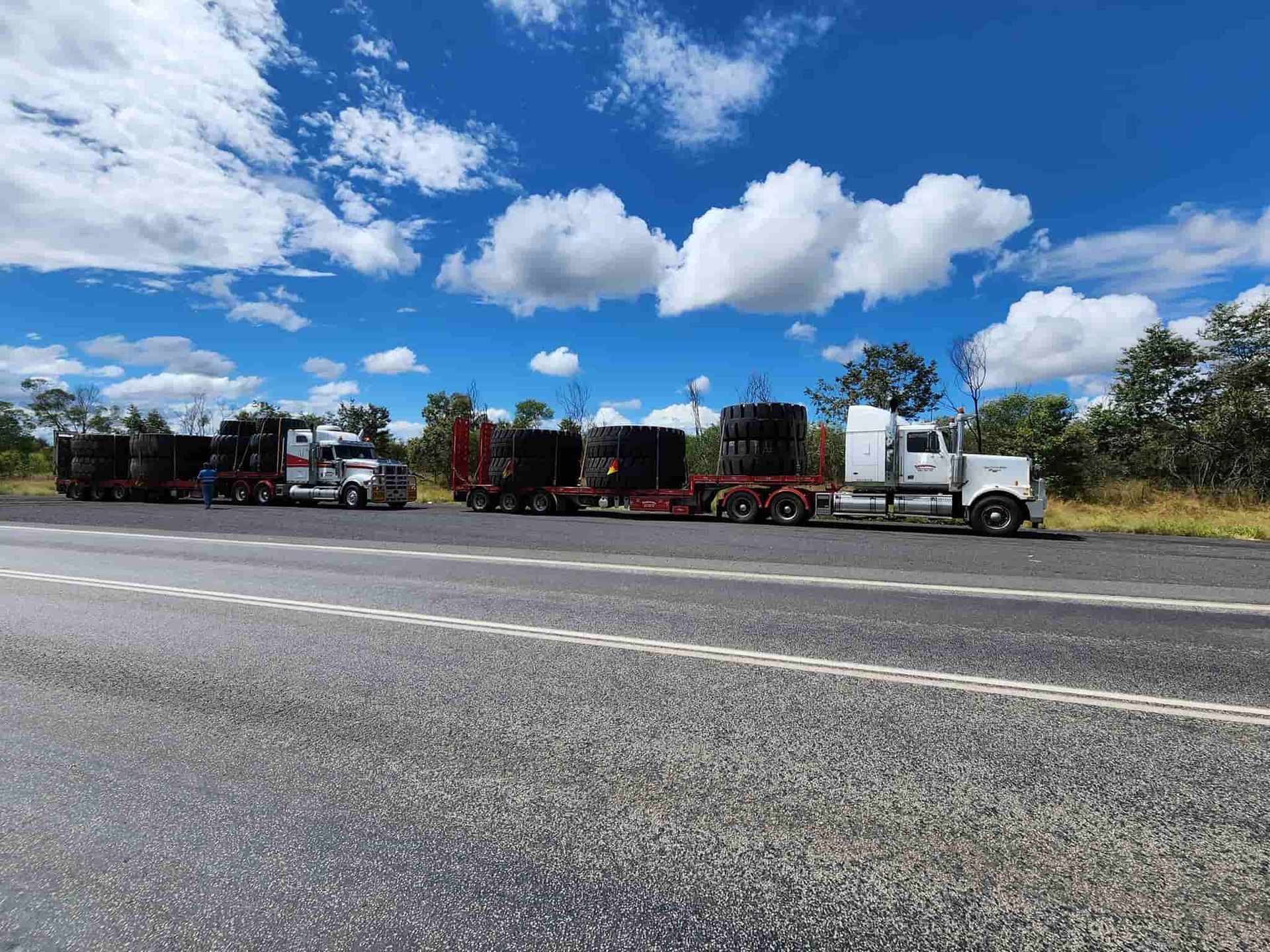 A Row Of Semi Trucks Are Parked On The Side Of A Highway — Equiptranz In Kybong, QLD
