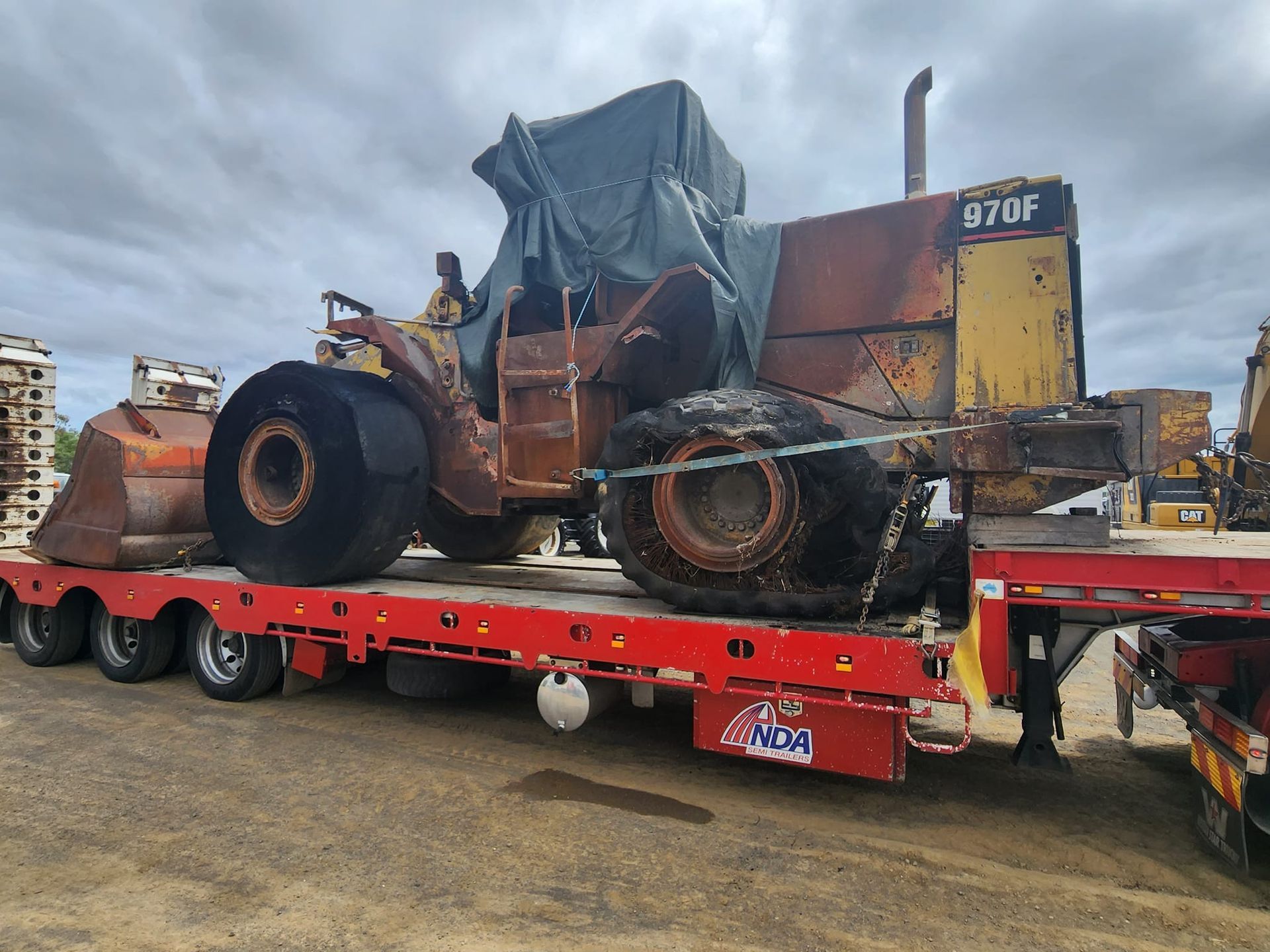 A large tractor is sitting on top of a flatbed trailer. — Equiptranz In Kybong, QLD