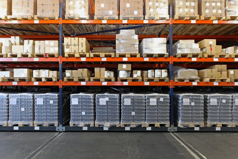 A Warehouse Filled With Lots Of Boxes And Pallets — Equiptranz In Kybong, QLD