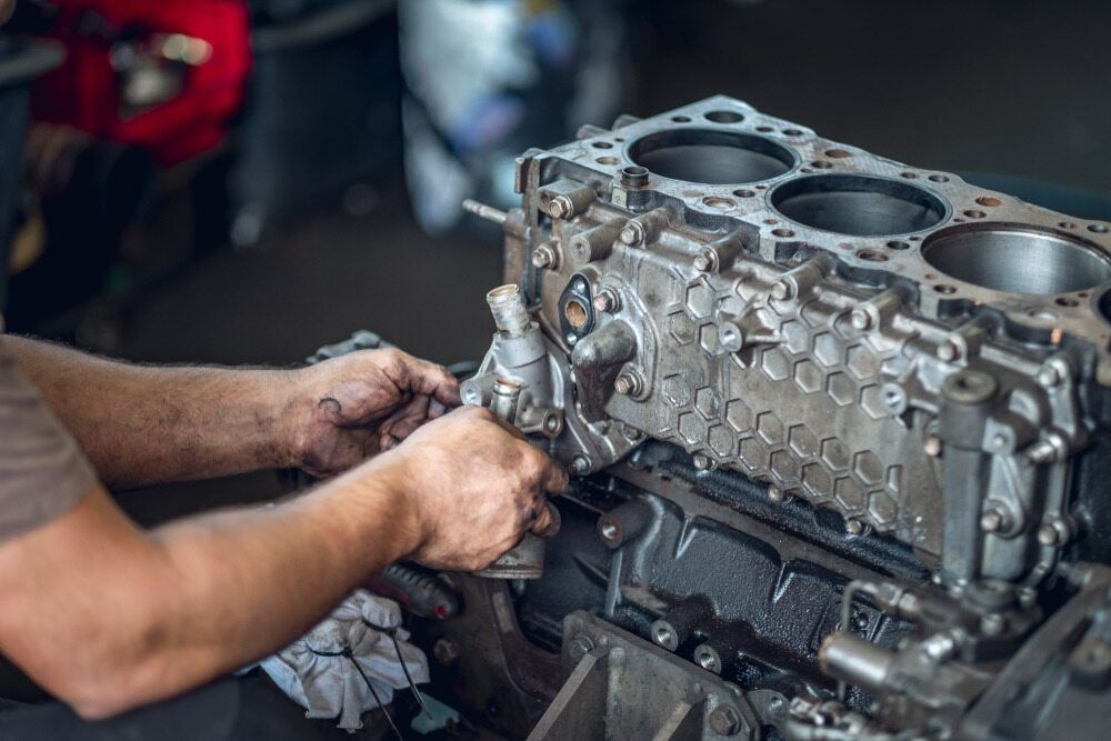 A Man is Working on a Car Engine in a Garage — Pelican Motors Service Centre In Caloundra West, QLD 